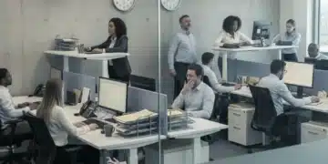 Disengaged office workers exhibiting quiet quitting behaviors in a modern workspace.